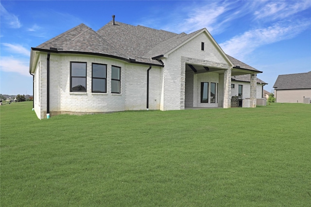 121 Ford Ct, Weston, TX 75009 - back of property featuring a lawn, brick siding, and roof with shingles