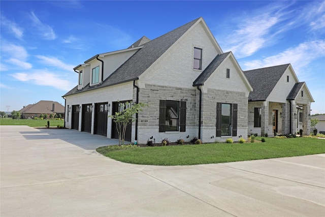 121 Ford Ct, Weston, TX 75009 - french country home with driveway, a garage, stone siding, a front lawn, and a shingled roof