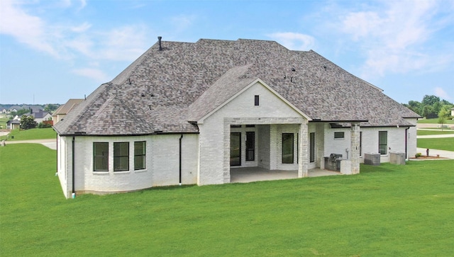 121 Ford Ct, Weston, TX 75009 - back of house with brick siding, a lawn, and a patio