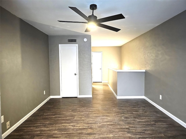 unfurnished room featuring dark hardwood / wood-style floors and ceiling fan