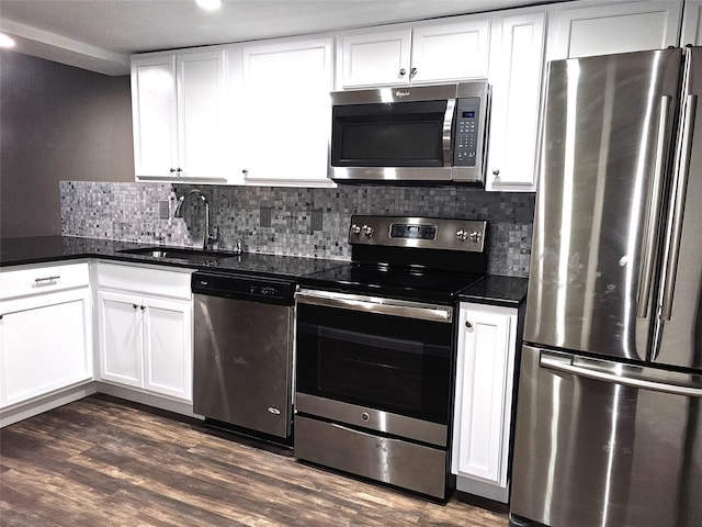 kitchen with white cabinetry, appliances with stainless steel finishes, sink, and backsplash