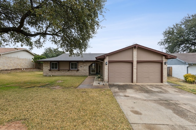 ranch-style house featuring a garage and a front lawn