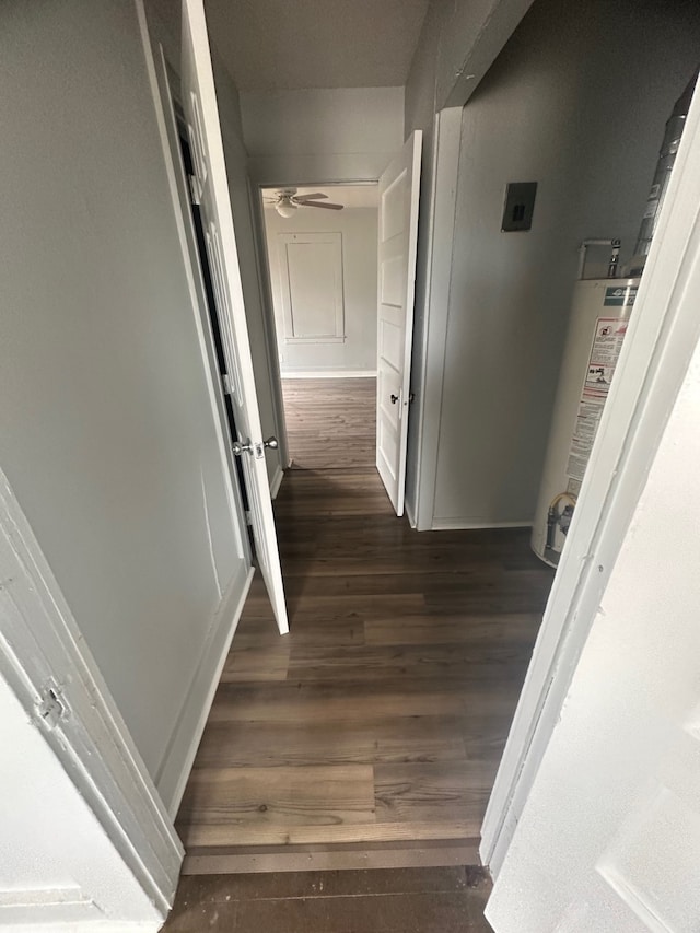 corridor featuring dark hardwood / wood-style floors and gas water heater