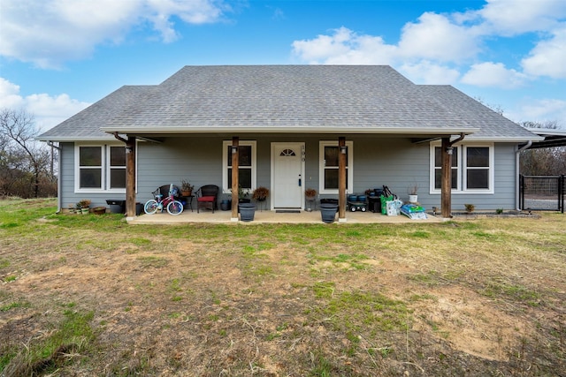 back of house featuring a lawn and a patio area