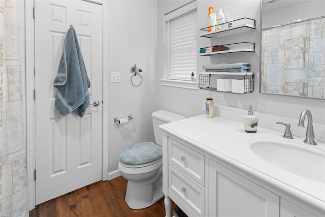 bathroom with wood-type flooring, toilet, and vanity