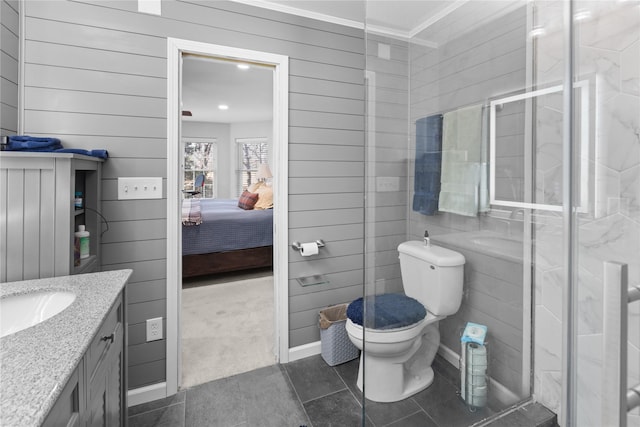 bathroom with vanity, tile patterned flooring, a shower with shower door, and toilet