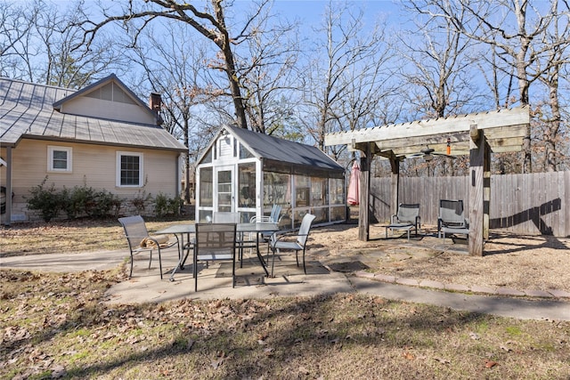 exterior space with an outbuilding, a pergola, and a patio area