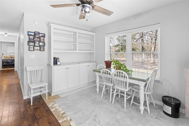 dining room with hardwood / wood-style flooring and ceiling fan