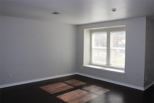 empty room featuring dark wood-type flooring