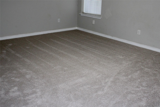 empty room featuring dark carpet