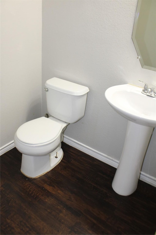 bathroom with hardwood / wood-style flooring, sink, and toilet