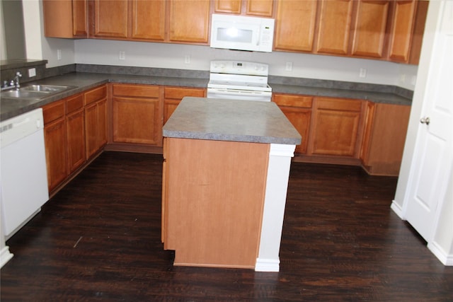 kitchen with white appliances, dark hardwood / wood-style flooring, and sink