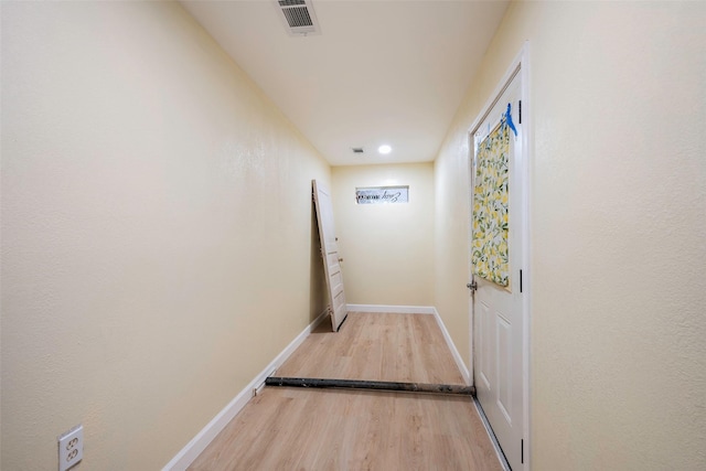 corridor with wood-type flooring