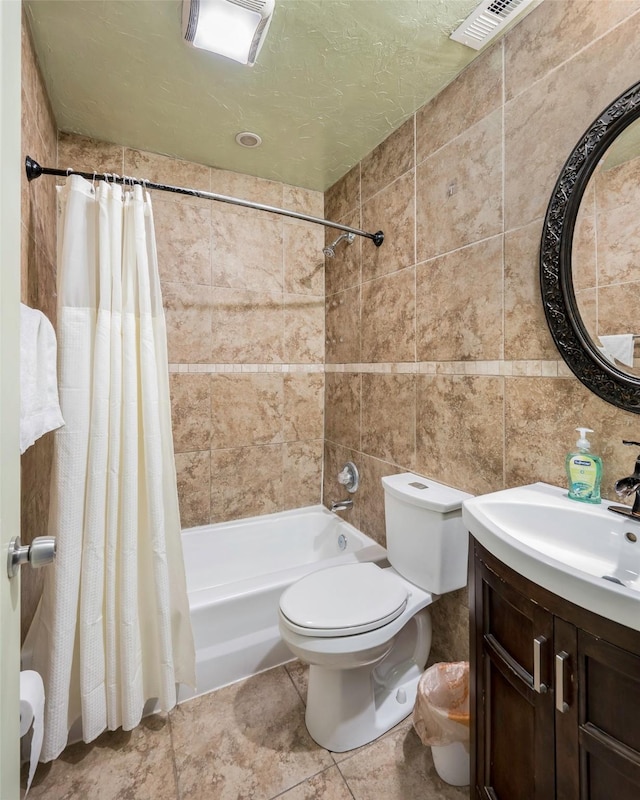 full bathroom featuring vanity, toilet, a textured ceiling, and shower / bath combo with shower curtain