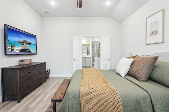 bedroom with baseboards, visible vents, ensuite bathroom, vaulted ceiling, and light wood-type flooring