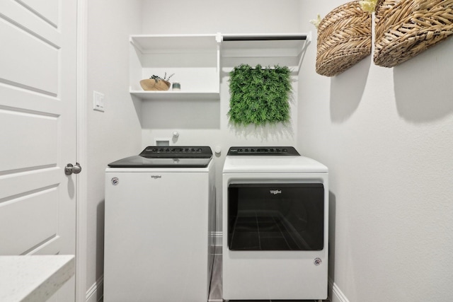 washroom featuring laundry area, independent washer and dryer, and baseboards