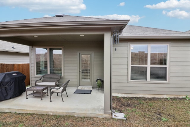 back of house with roof with shingles, a patio, and fence