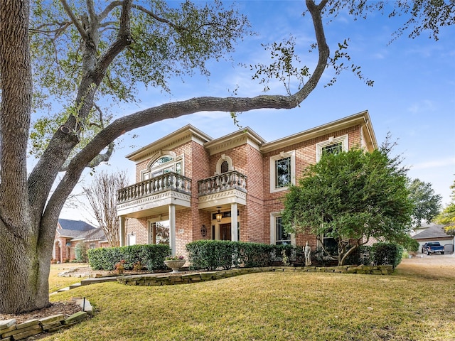 view of front of property with a balcony and a front yard