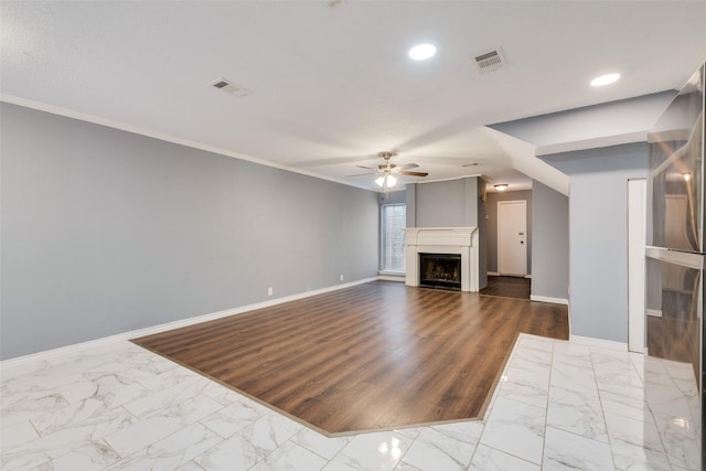 unfurnished living room with marble finish floor, baseboards, a fireplace, and visible vents