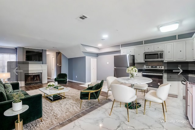 interior space with recessed lighting, a fireplace, visible vents, baseboards, and marble finish floor