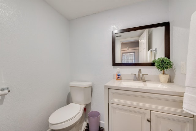 bathroom featuring toilet and vanity