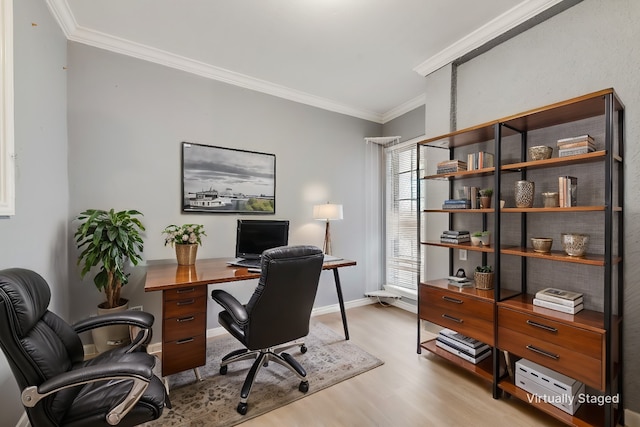 office space with light wood-style flooring, ornamental molding, and baseboards