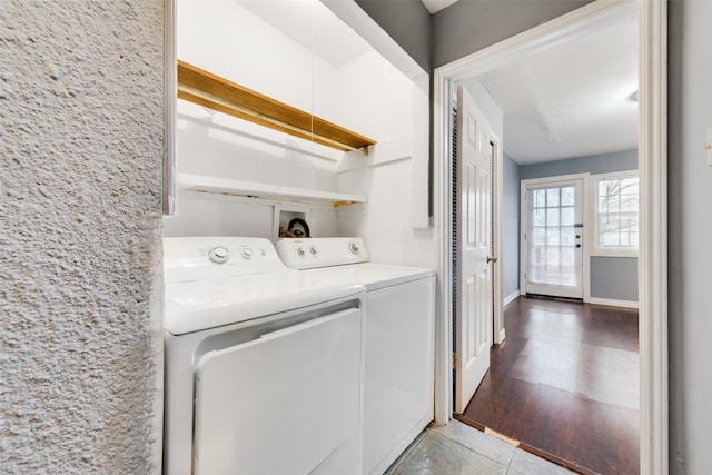 washroom featuring laundry area, light tile patterned flooring, independent washer and dryer, and baseboards