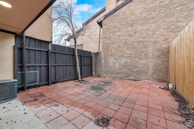 view of patio / terrace with fence and central AC unit