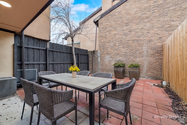 view of patio featuring fence and outdoor dining space