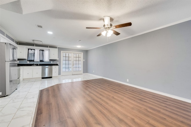 unfurnished living room with marble finish floor, baseboards, visible vents, and ornamental molding