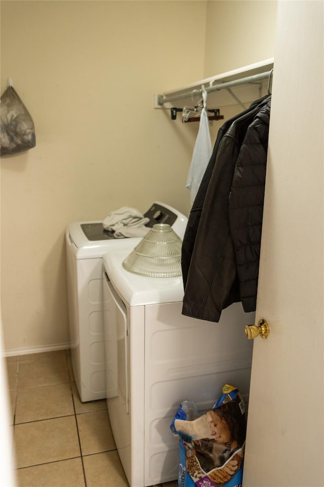 washroom with independent washer and dryer and light tile patterned flooring