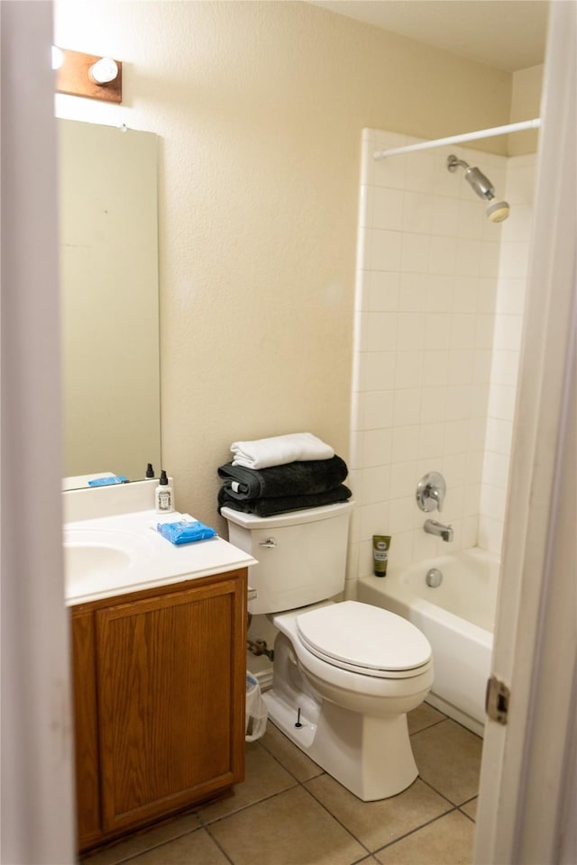 full bathroom featuring vanity, tiled shower / bath combo, tile patterned floors, and toilet