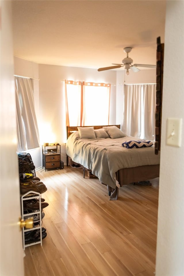 bedroom featuring wood-type flooring and ceiling fan