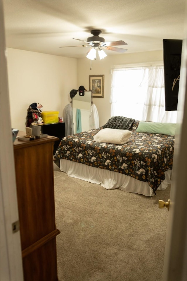 bedroom with ceiling fan and carpet flooring