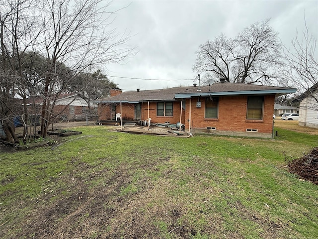 rear view of house with a patio area and a lawn