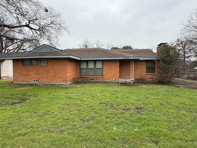 back of property featuring a lawn