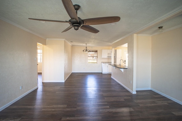 unfurnished living room with a textured ceiling, dark wood-type flooring, a sink, and baseboards