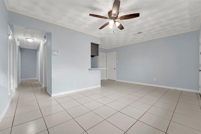 tiled empty room with ornamental molding and ceiling fan