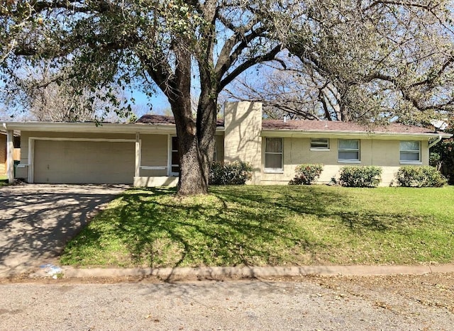 single story home featuring a garage and a front lawn