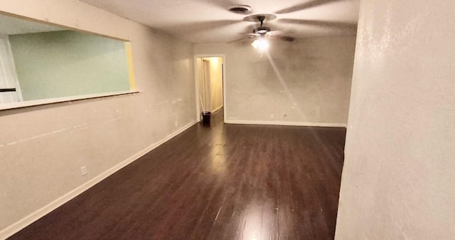 spare room with dark hardwood / wood-style flooring and ceiling fan