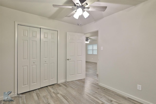 unfurnished bedroom with a closet, ceiling fan, and light wood-type flooring