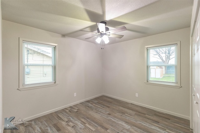 spare room featuring ceiling fan, hardwood / wood-style floors, and a textured ceiling