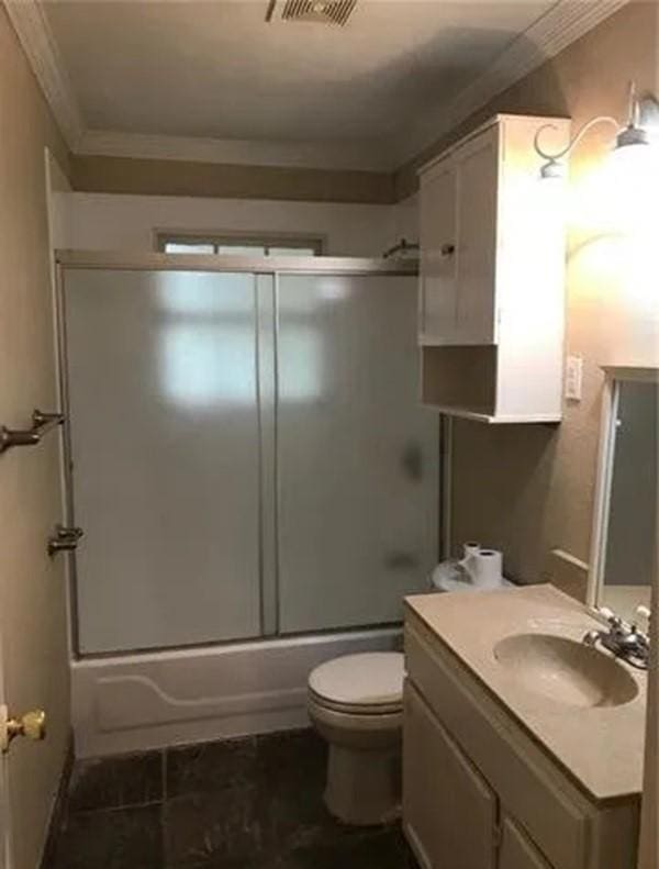 full bathroom with vanity, crown molding, toilet, and combined bath / shower with glass door