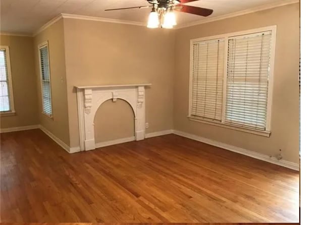 unfurnished living room featuring crown molding, a high end fireplace, hardwood / wood-style floors, and ceiling fan