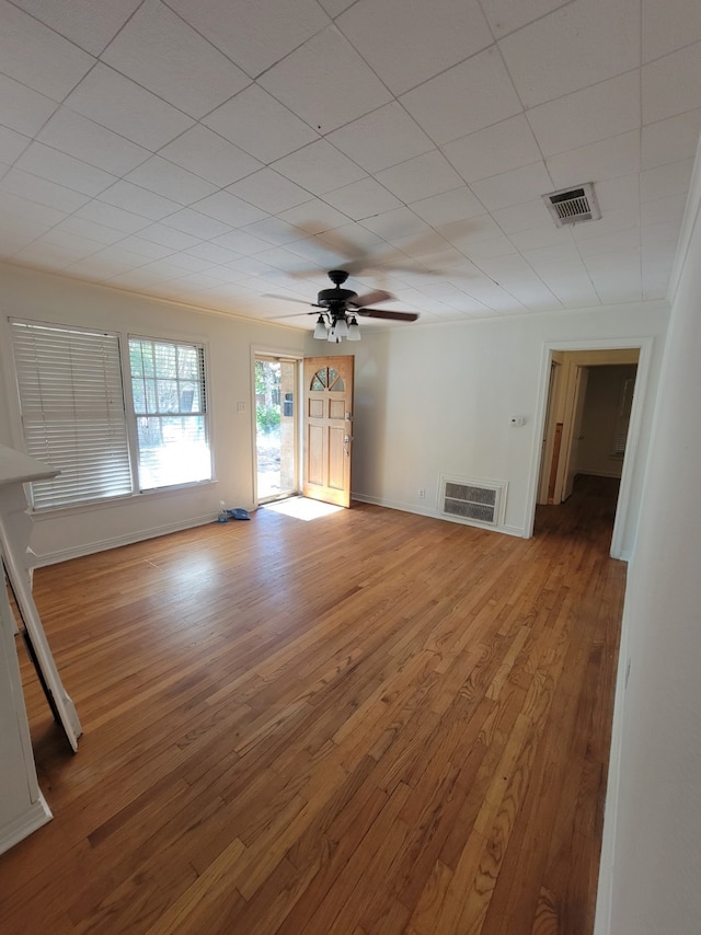 unfurnished living room with crown molding, ceiling fan, and hardwood / wood-style floors