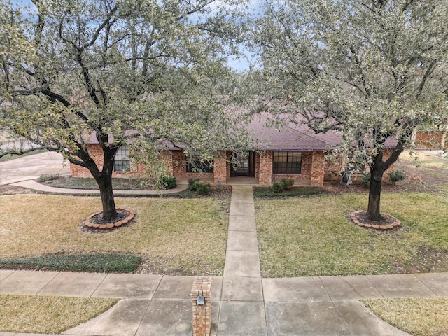 ranch-style house with a front lawn