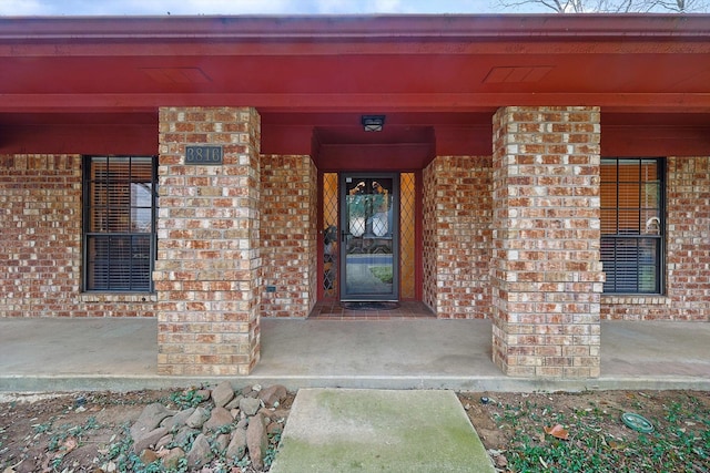 view of exterior entry featuring a porch