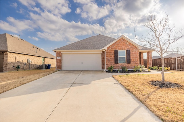 ranch-style home featuring a garage and cooling unit