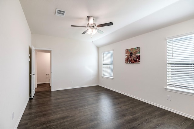 empty room featuring ceiling fan, lofted ceiling, and dark hardwood / wood-style flooring