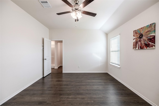 empty room with vaulted ceiling, ceiling fan, and dark hardwood / wood-style flooring